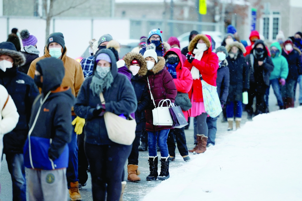 People queue to pick up coronavirus disease (COVID-19) antigen test kits, as the latest Omicron variant emerges as a threat, in Ottawa, Ontario, Canada, on Wednesday. — Reuters