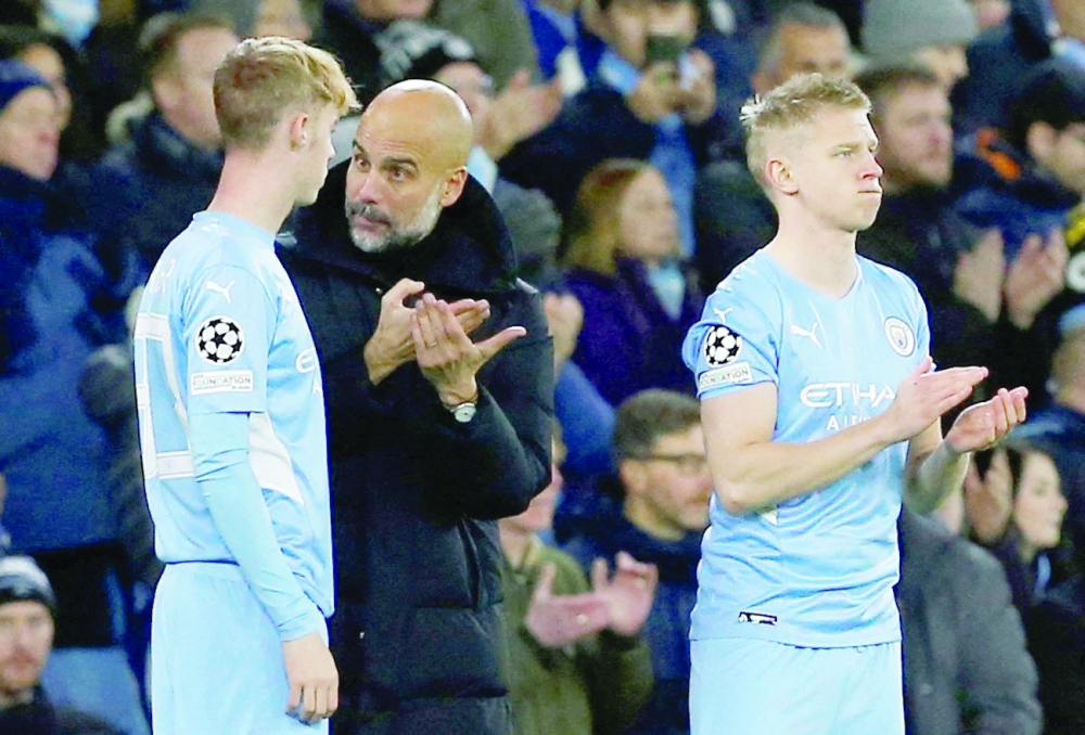 Manchester City's Cole Palmer with manager Pep Guardiola before coming on as a substitute to replace Phil Foden while Oleksandr Zinchenko looks on. -- Reuters