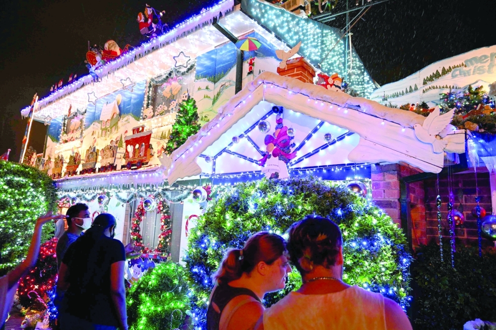 Residents of Western Sydney visiting a house decorated in festive lighting and ornaments ahead of Christmas. - AFP