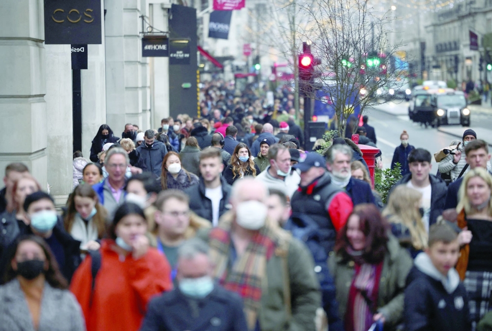 Shoppers walk along Regent Street, amid the Covid-19 outbreak in London. - Reuters