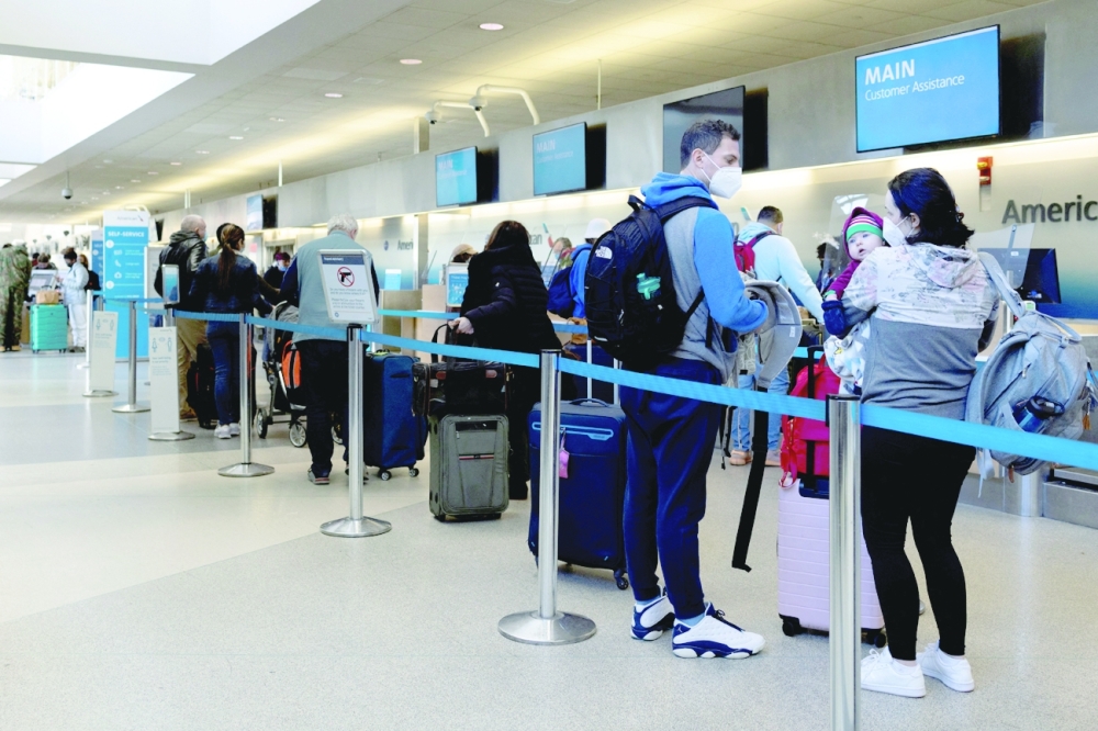 Travellers wait in line at the Philadelphia International Airport, Pennsylvania, US, on Thursday. - Reuters