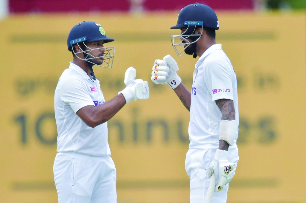 India's Mayank Agarwal (R) and India's KL Rahul (L) bump fists during the first day of the first Test in Centurion. -- AFP

