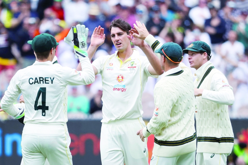 Pat Cummins of Australia celebrates with team-mates after dismissing Zak Crawley of England in the third Ashes Test at Melbourne Cricket Ground. -- Reuters
