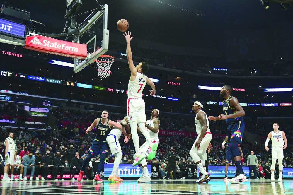 sv5Dec 26, 2021; Los Angeles, California, USA; Los Angeles Clippers guard Amir Coffey (7) plays for the ball against the Denver Nuggets during the second half at Crypto.com Arena. Mandatory Credit: Gary A. Vasquez-USA TODAY Sports
