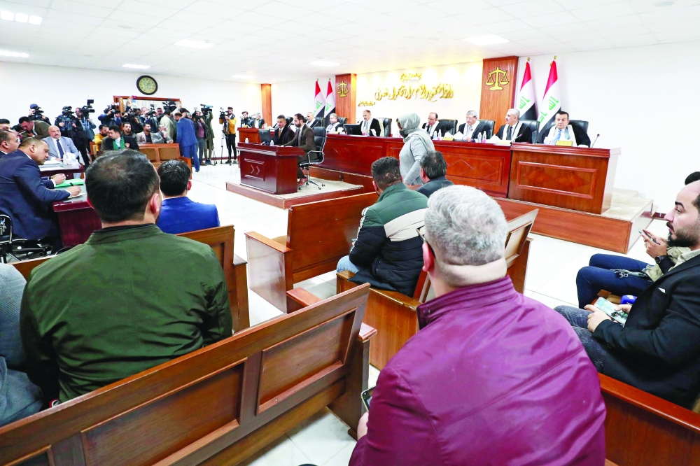 Iraqis attend a court session at the Supreme Judicial Council in Baghdad on Monday. - AFP 