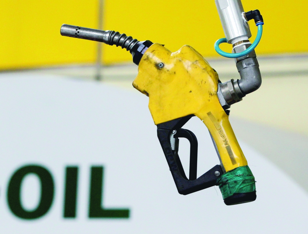 A gas pump is seen hanging from the ceiling at a petrol station in Seoul, South Korea. — Reuters