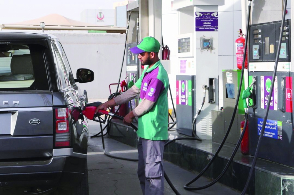 A worker fills a vehicle with petrol at a gas station in Riyadh, Saudi Arabia. — Reuters