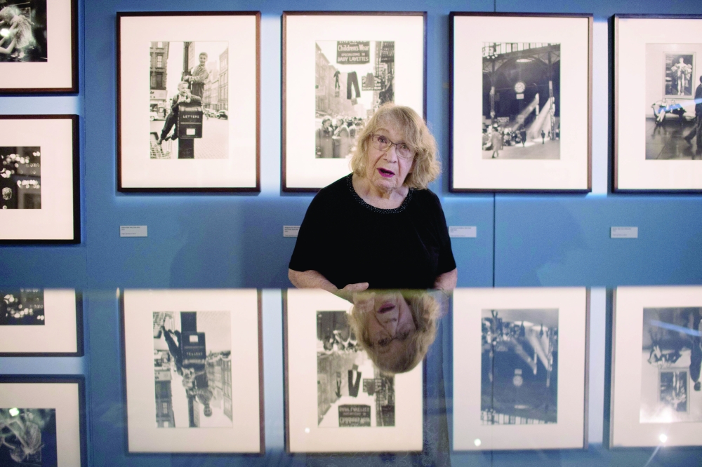 Sabine Weiss posing in front of her pictures as she visits a retrospective exhibition of her work. — AFP 