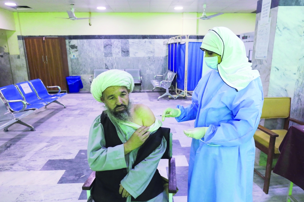 A man receives a Covid-19 vaccine in Peshawar. -- Reuters