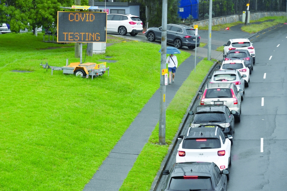 People queue in their cars for PCR testing at a clinic in Sydney.  -- Reuters