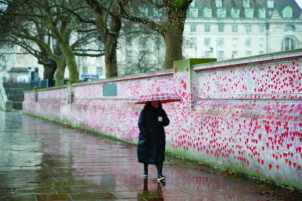 A pedestrian walks past the National Covid Memorial Wall in London on Wednesday. — AFP 