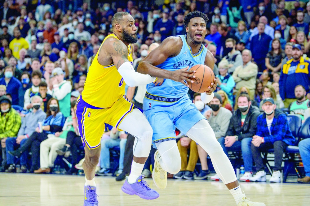 Memphis Grizzlies forward Jaren Jackson Jr. (13) drives to the basket past Los Angeles Lakers forward LeBron James (6). -- USA Today Sports
