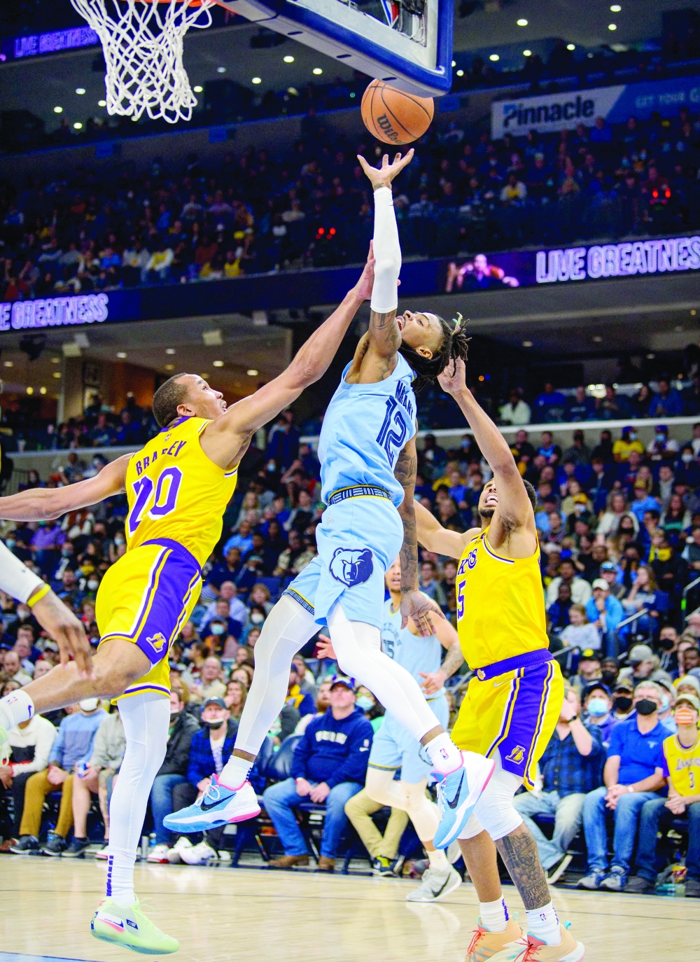 Memphis Grizzlies guard Ja Morant (12) is fouled by Los Angeles Lakers guard Avery Bradley (20) during the second half at the FedExForum. -- USA Today Sports

