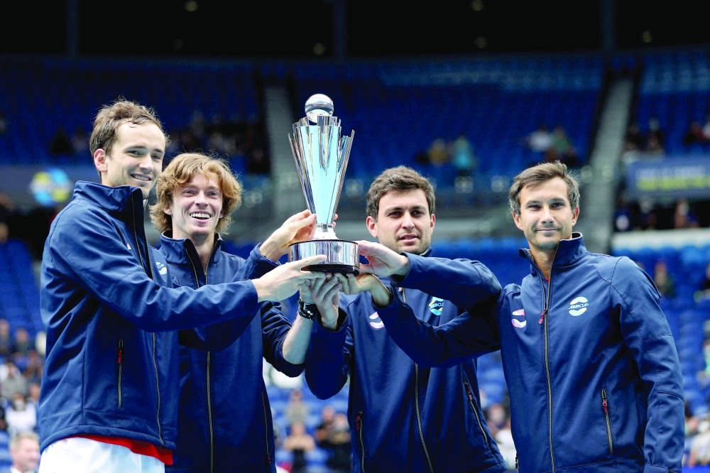 Russia's Daniil Medvedev, Andrey Rublev, Aslan Karatsev and Evgeny Donskoy celebrate winning the 2021 ATP Cup with the trophy after their final against Italy. -- Reuters