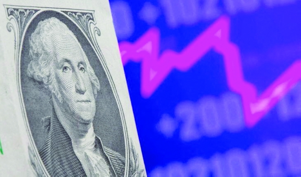 FILE PHOTO: A U.S. one dollar banknote is seen in front of displayed stock graph in this illustration