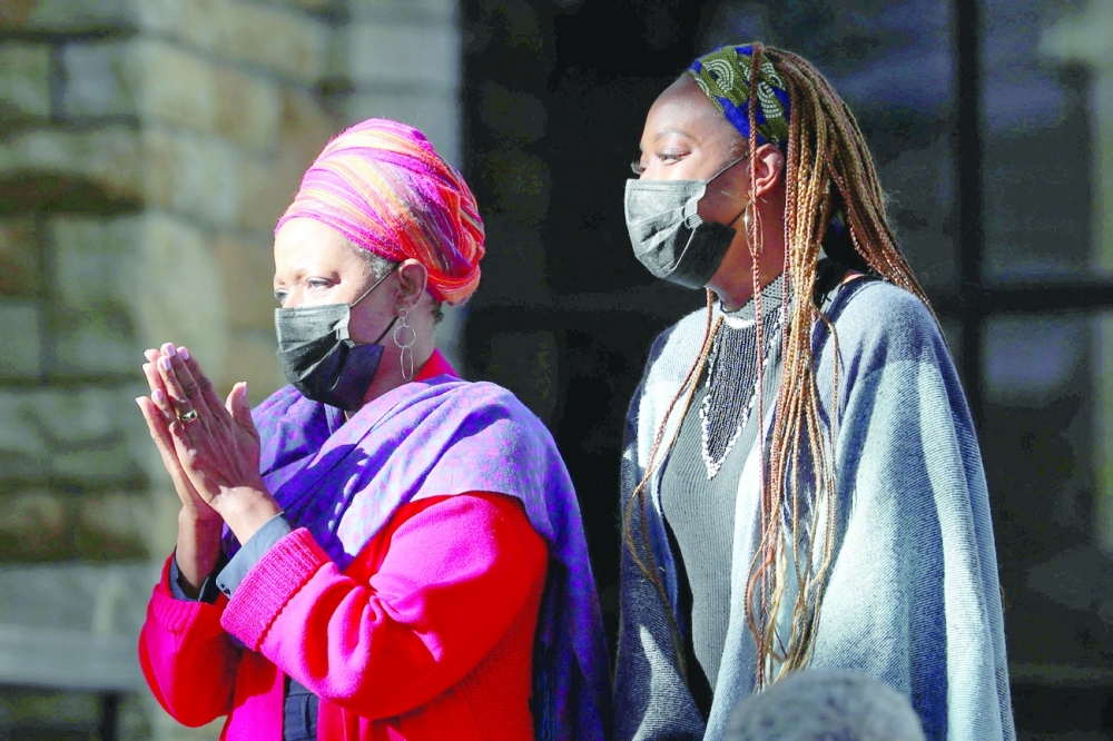 Mpho Tutu Van Furth, daughter of late Archbishop Desmond Tutu, and his granddaughter Nyaniso Burris Tutu, wait for the arrival of the casket containing his body at St Georges Cathedral, in Cape Town, on Friday. - Reuters