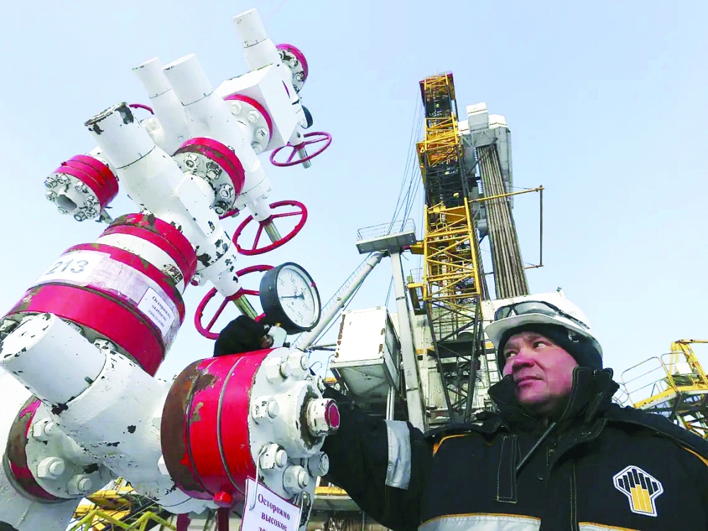 A worker checks a pressure gauge at an oil pumping station near the Rosneft company owned Suzunskoye oil field in Krasnoyarsk, Russia. — Reuters