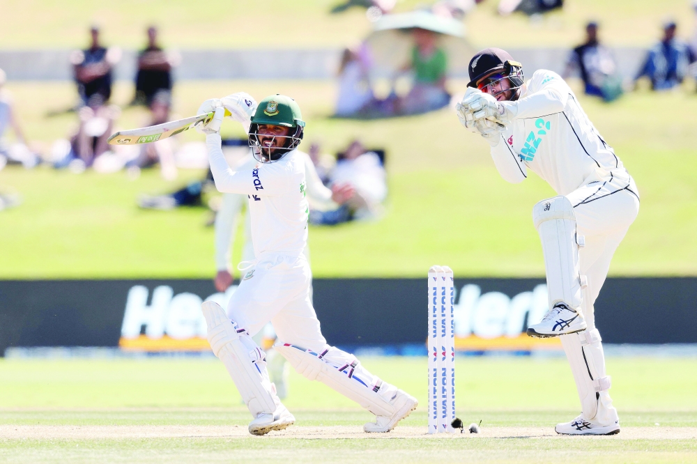 Bangladesh's batsman Mominul Haque plays a shot as New Zealand's wicketkeeper Tom Blundell (R) looks on. -- AFP
