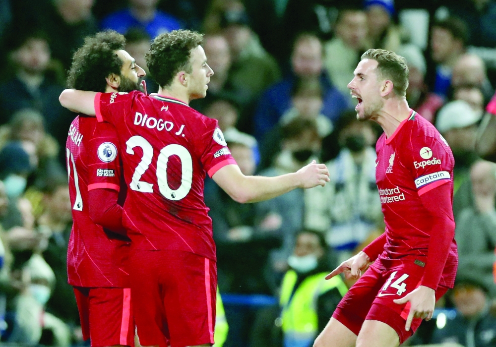 Liverpool's Mohamed Salah celebrates scoring their second goal with Diogo Jota and Jordan Henderson. -- Reuters
