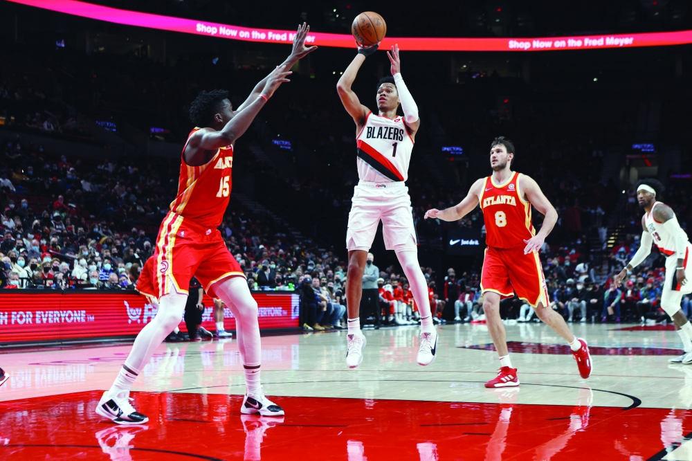 Jan 3, 2022; Portland, Oregon, USA; Portland Trail Blazers guard Anfernee Simons (1) shoots over Atlanta Hawks center Clint Capela (15) in the first half at Moda Center. Mandatory Credit: Jaime Valdez-USA TODAY Sports
