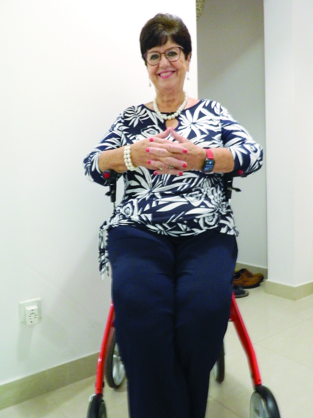 Elly Hollemans seated in her walker