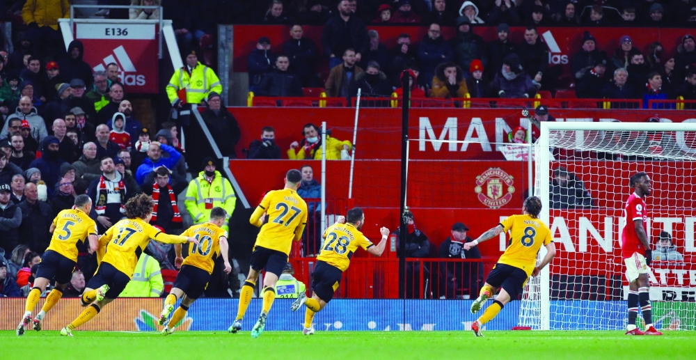 Soccer Football - Premier League - Manchester United v Wolverhampton Wanderers - Old Trafford, Manchester, Britain - January 3, 2022 Wolverhampton Wanderers' Joao Moutinho celebrates scoring their first goal with teammates REUTERS/Phil Noble EDITORIAL USE ONLY. No use with unauthorized audio, video, data, fixture lists, club/league logos or 'live' services. Online in-match use limited to 75 images, no video emulation. No use in betting, games or single club /league/player publications.  Please contact your account representative for further details.
