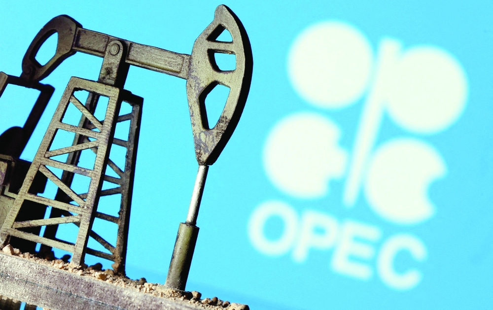 A 3D printed oil pump jack is seen in front of displayed OPEC logo in this illustration picture. — Reuters