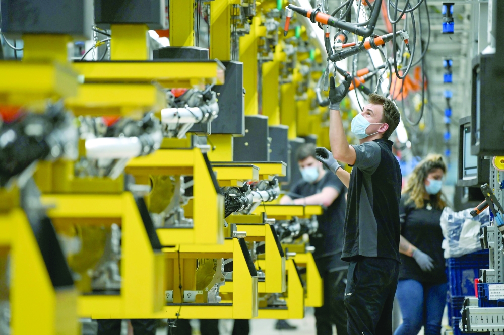 Workers assemble engines at the Daimler Powertrain plant in Bad Cannstatt near Stuttgart, Germany. — Reuters
