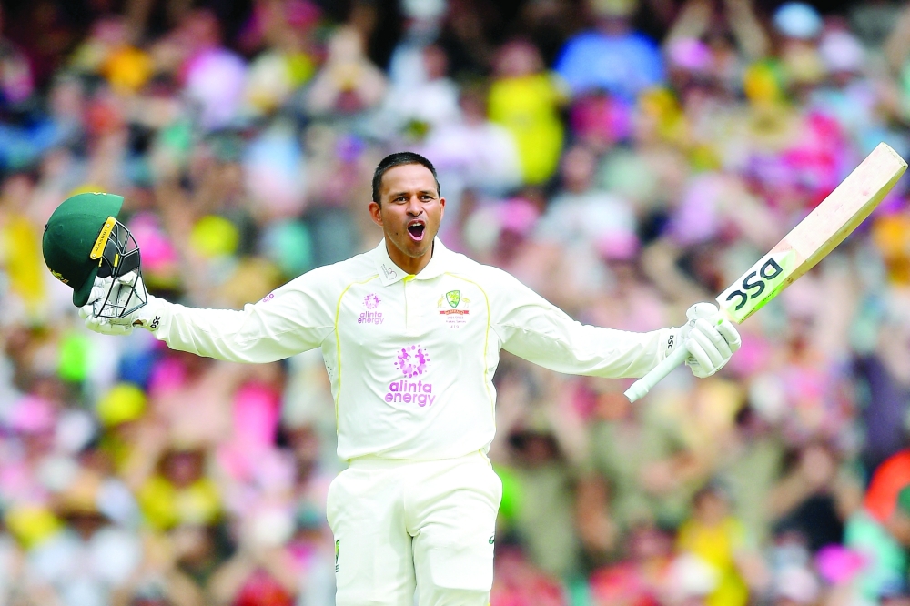 Australia's Usman Khawaja celebrates his century. -- Reuters