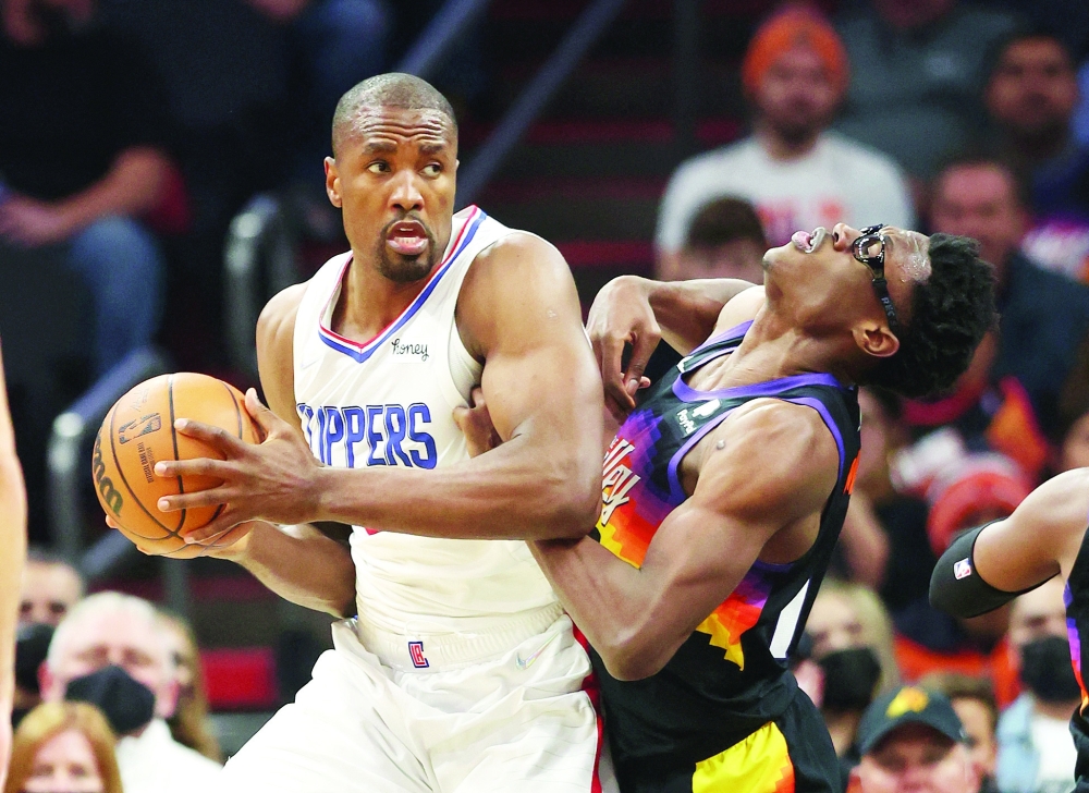 Los Angeles Clippers center Serge Ibaka (left) drives to the basket against Phoenix Suns forward Jalen Smith in the second half at Footprint Center. -- USA Today Sports
