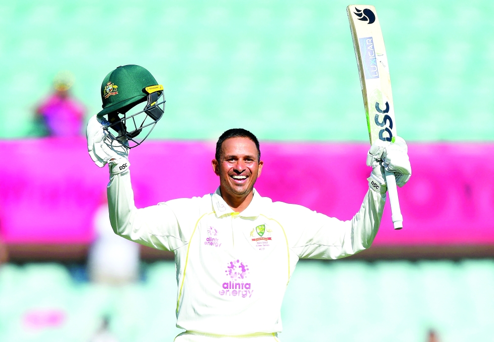 Australia's Usman Khawaja celebrates his century. -- Reuters