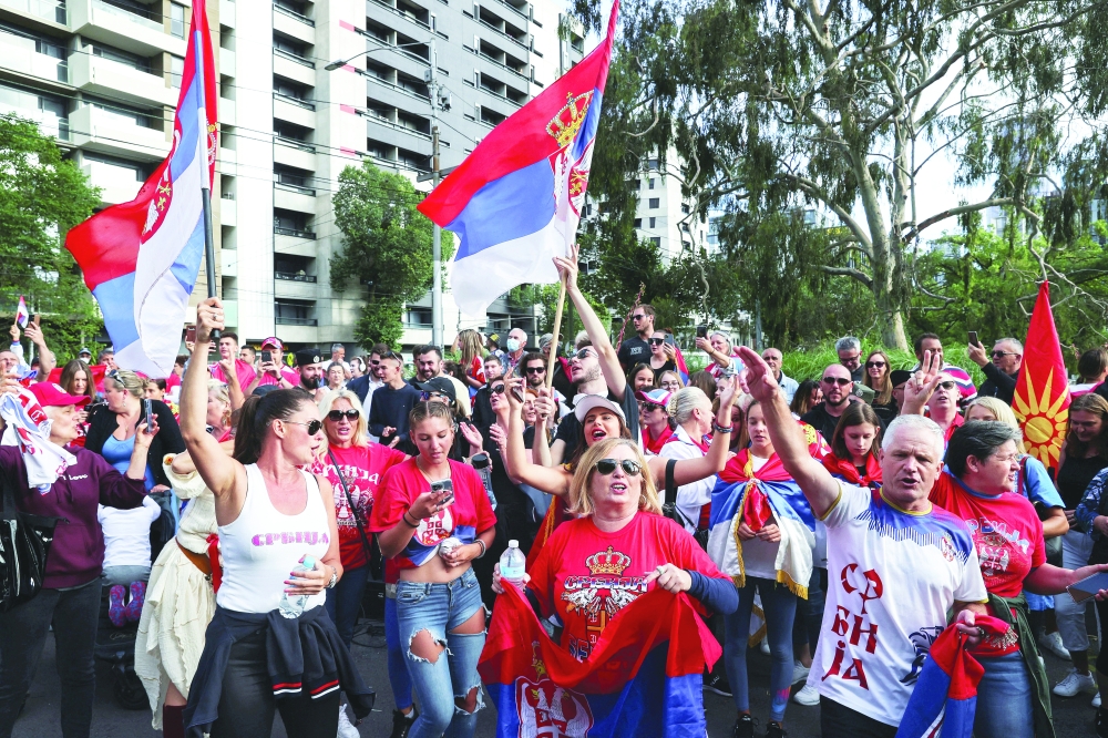 Supporters of Serbian tennis player Novak Djokovic rally outside the Park Hotel, where the star athlete is believed to be held while he stays, in Melbourne. -- Reuters
