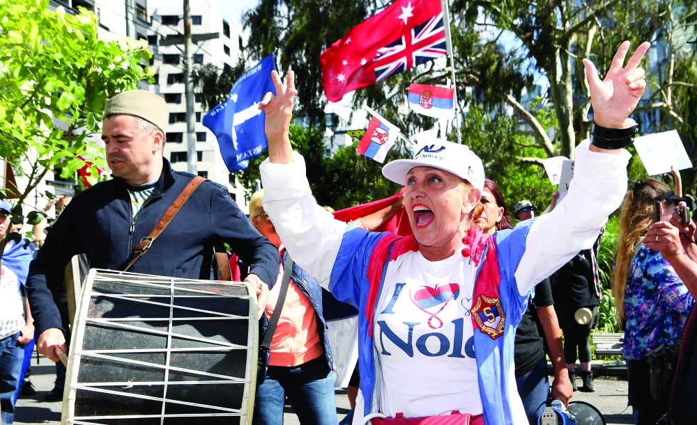 People gather outside a government detention centre where Serbia's tennis champion Novak Djokovic is reported to be staying in Melbourne. -- AFP