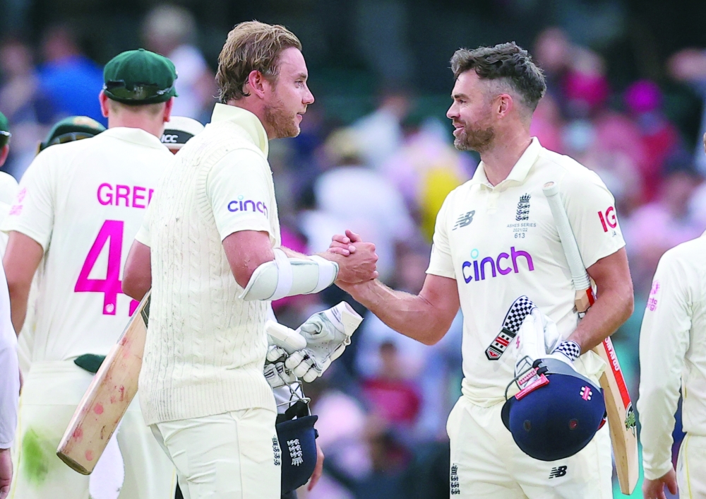 England's Stuart Broad (L) and James Anderson shake hands at the end of day five and the fourth Ashes Test at the Sydney Cricket Ground. -- AFP