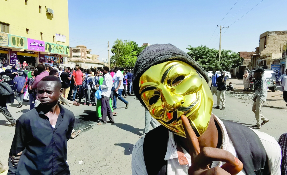 A mask-clad Sudanese protester during a protest against the October 2021 military coup in Khartoum. - AFP