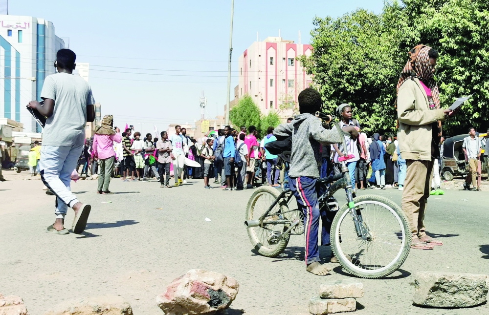 Sudanese protesers rally near a road block during a protest against the October 2021 military coup in Khartoum. - AFP 