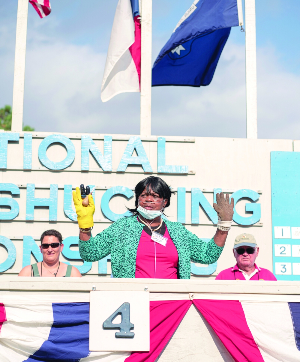 Deborah Pratt, a prize-winning oyster shucker from Jamaica, Va., at theSt. Marys County Oyster Festival and National Shucking Competitionin Leonardtown, Md.,Oct. 16, 2021. (Shan Wallace/The New York Times)