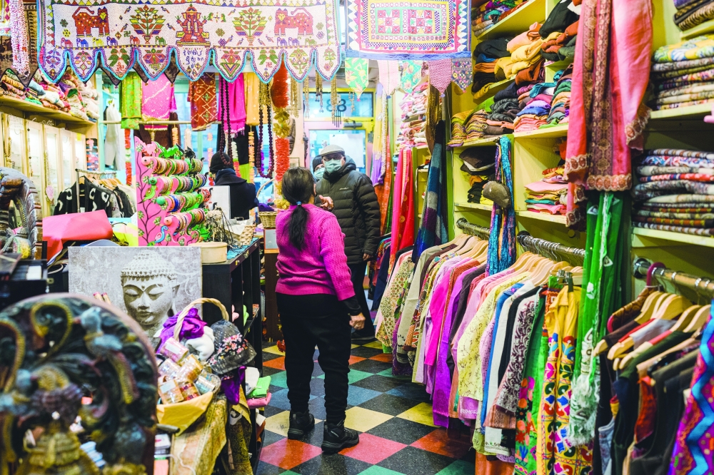 Saroj Goyal greets shoppers at her store Dress Shoppe II in the East Village on Dec. 23, 2021. (Gabriela Bhaskar/The New York Times)