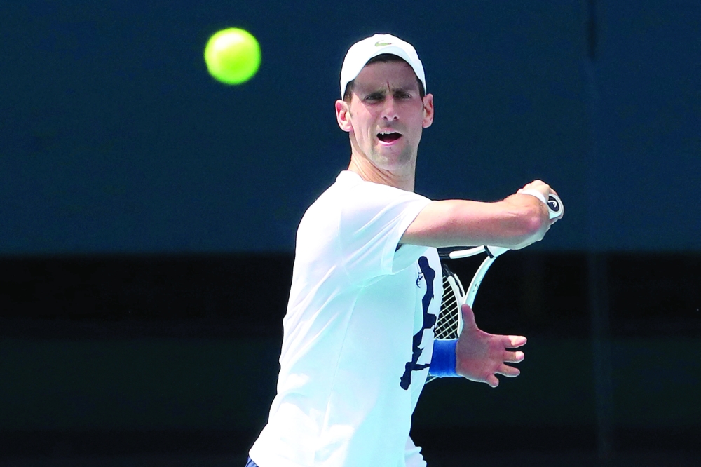Serbian tennis player Novak Djokovic practices on Rod Laver Arena ahead of the 2022 Australian Open at Melbourne Park, in Melbourne, Australia, January 11, 2022. Kelly Defina/Pool via REUTERS
