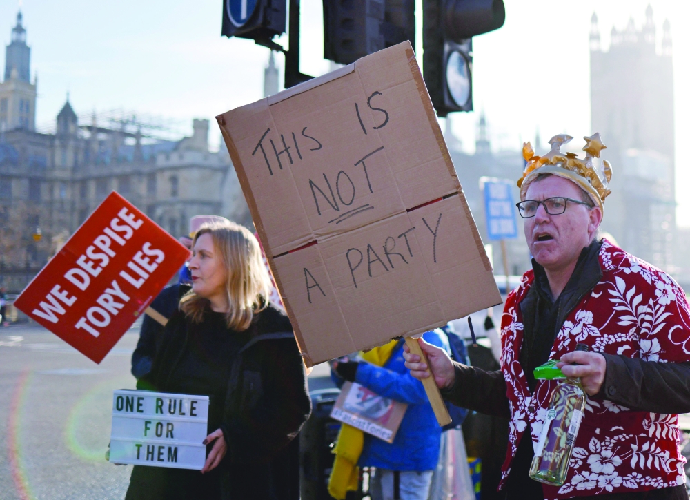 Demonstrators protest near the House of Commons, where Britain's Prime Minister was taking part in the weekly session of Prime Minister Questions (PMQs) in central London. - AFP 