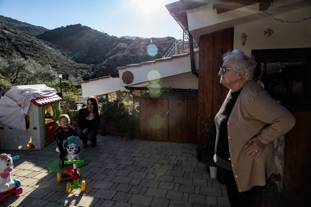 Bruna Danei plays with her daughter Arianna at their house in Campese, Italy on Giglio island, Jan. 13, 2022. 