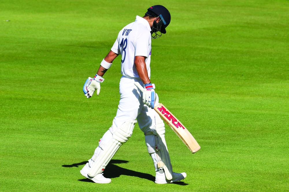 (FILES) In this file photo taken on January 11, 2022, India's Virat Kohli walks back to the pavilion after his dismissal during the first day of the third Test. -- AFP