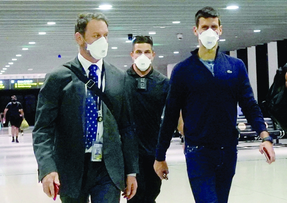 Novak Djokovic walks in Melbourne Airport before boarding a flight in Melbourne. -- Reuters