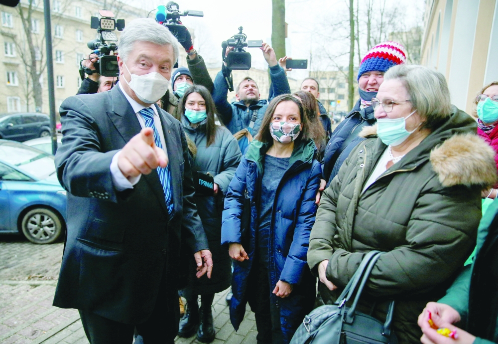 Ukrainian former President Petro Poroshenko meets with his supporters and journalists ahead of a news conference in Warsaw. - Reuters 