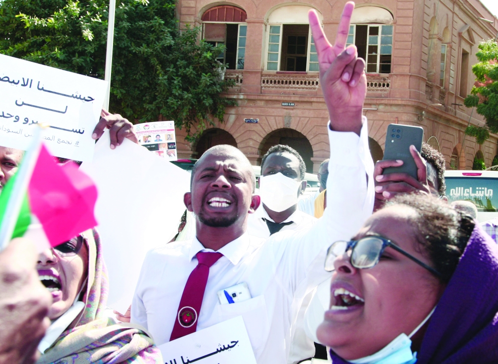 Dozens of Sudanese doctors demonstrate in Khartoum to denounce attacks by security forces against medical personnel and doctors during pro-democracy rallies opposed to the October military coup. - AFP