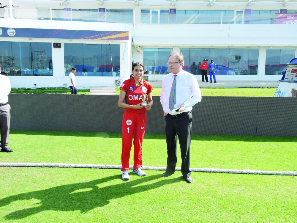 Player of the match Vaishali Jesrani receiving her prize from Paul Sheridan, Oman Cricket Board Member.