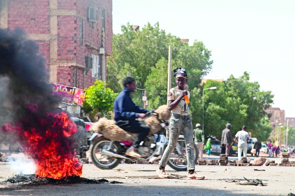 Sudanese demonstrators barricade Al Sahafa street with rocks and burning tyres during ongoing protests against a military coup in Khartoum. - AFP