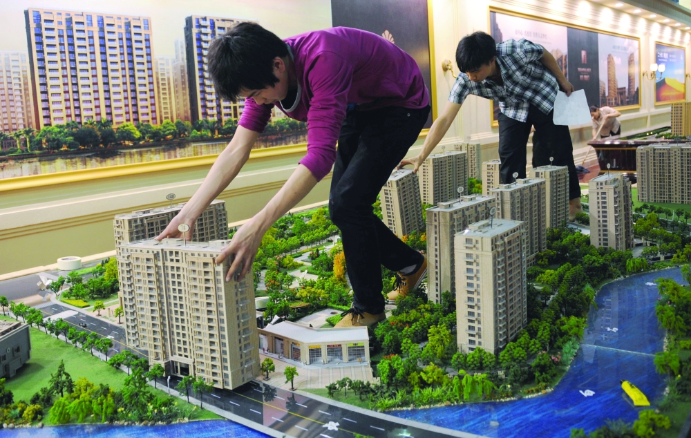 Employees set up model apartments as they prepare a real estate exhibition in Hangzhou, Zhejiang province. — Reuters