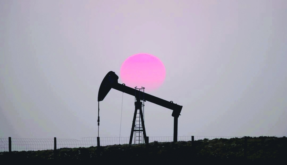 The sun sets behind an oil pump outside Saint-Fiacre, near Paris. — Reuters