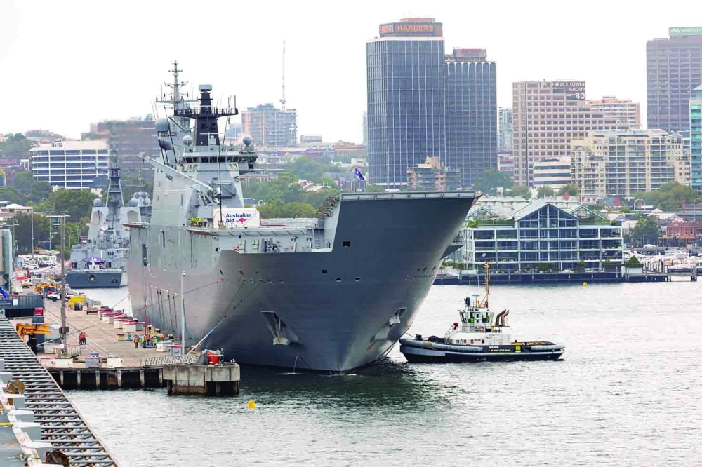 HMAS Adelaide departs Fleet Base East at Garden Island, Sydney, Australia, for Brisbane in preparation to provide disaster relief and assistance to Tonga. - Reuters
